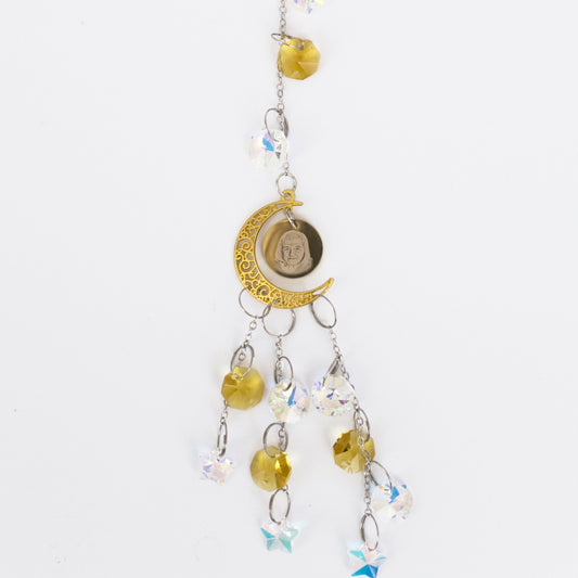 Decorative engraved hanging charm with yellow beads and a moon symbol on a white background