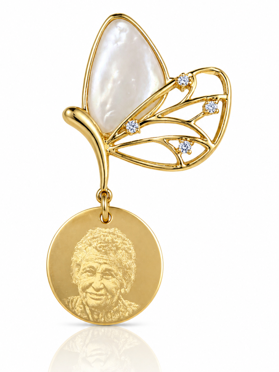 Gold butterfly pendant with a circular medallion featuring a portrait on a white background