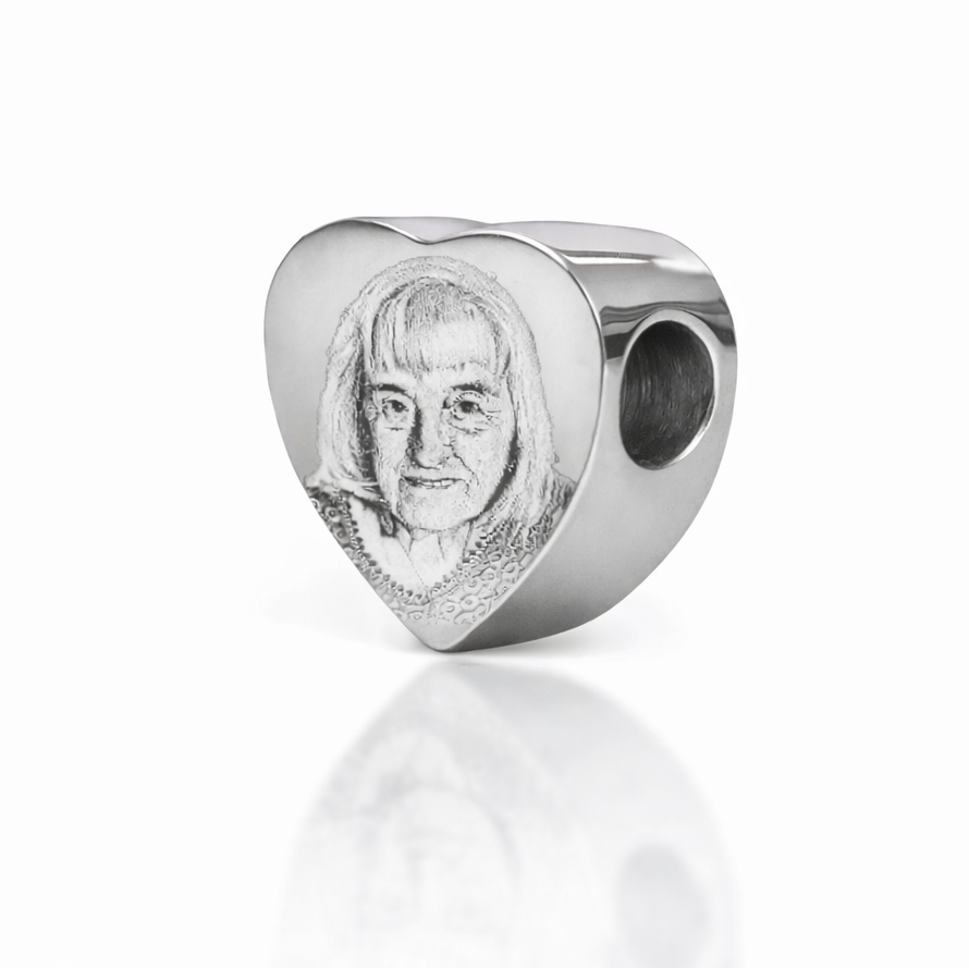 Silver pandora heart charm with a face photo engraving on a white background