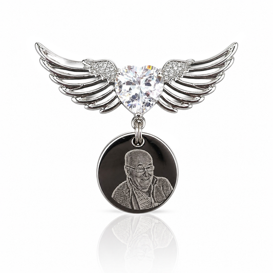 Pendant with heart-shaped crystal and wings on a white background