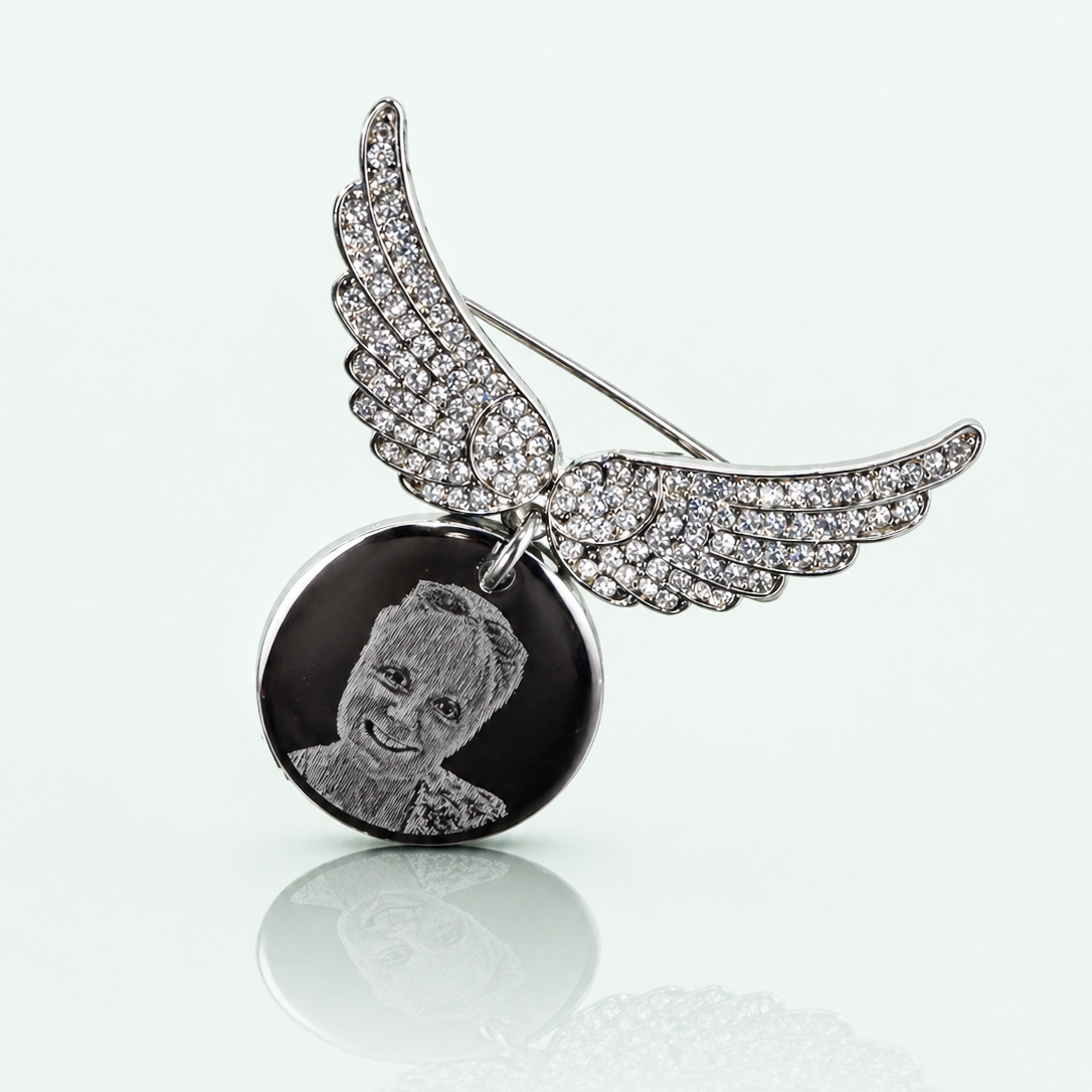Personalised Photo Brooch with angel wings and a round pendant on a white background