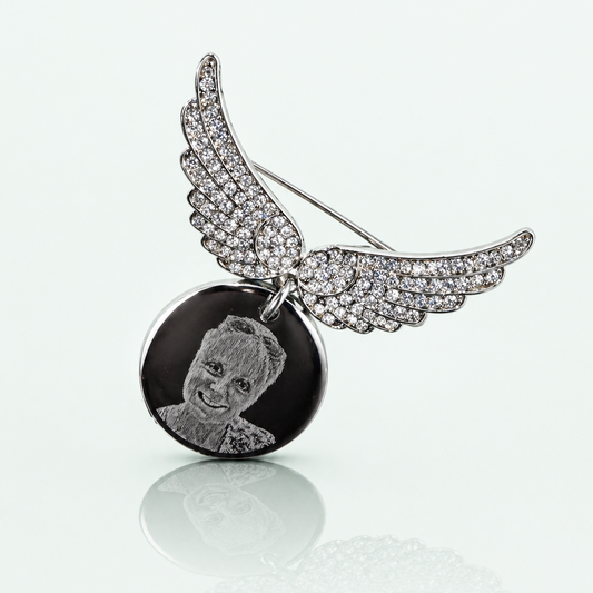 Personalised Photo Brooch with angel wings and a round pendant on a white background