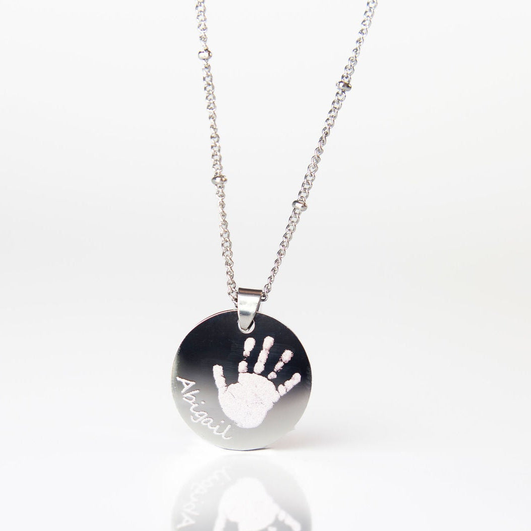 Silver circle handprint engraved necklace