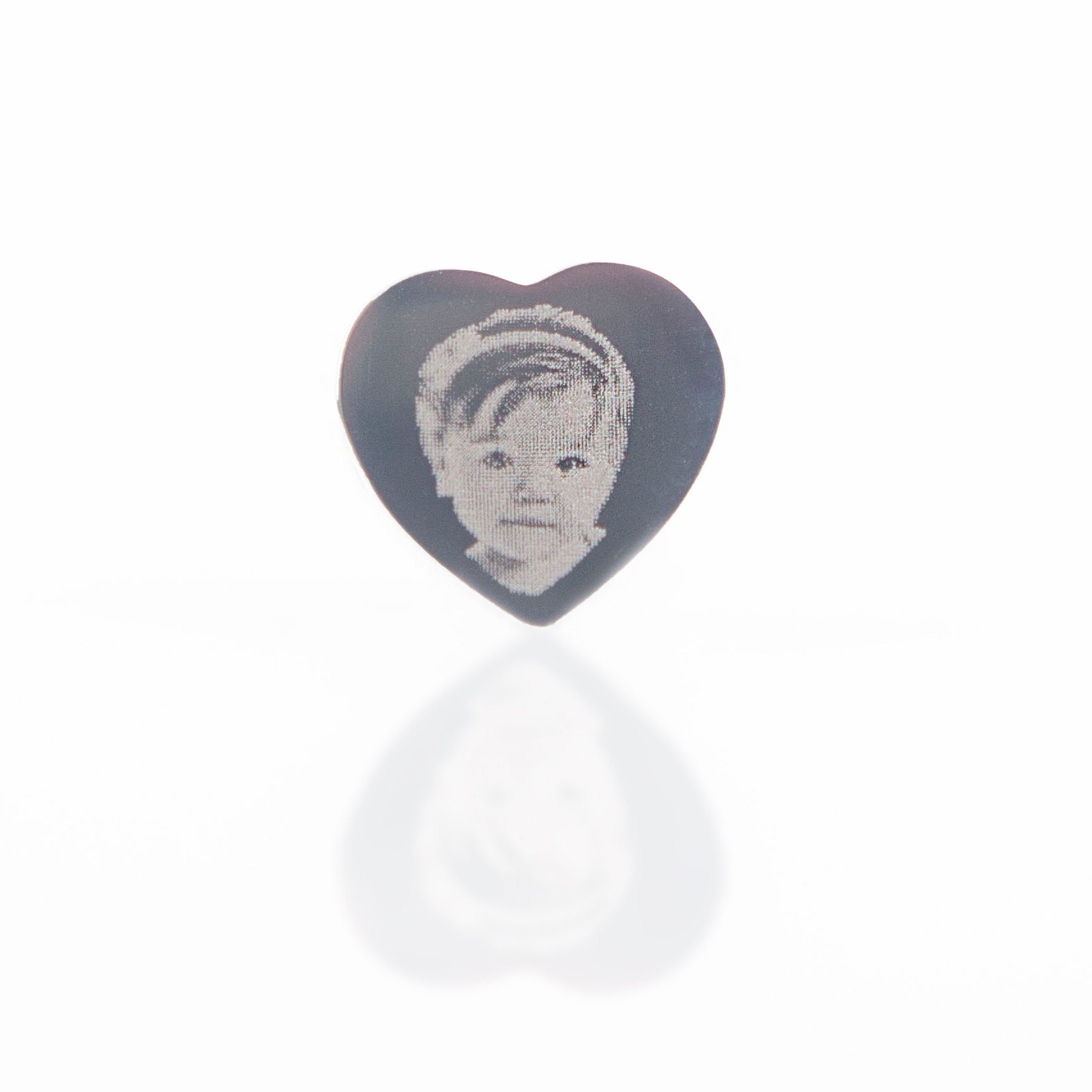 Heart-shaped object with a portrait on a white background