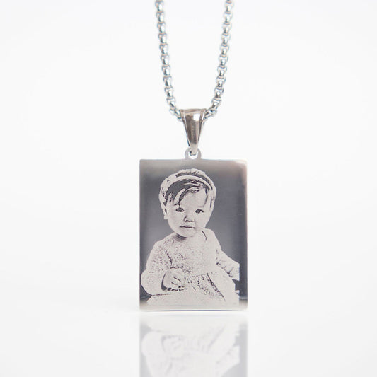Necklace with a pendant featuring an engraved image of a child on a white background