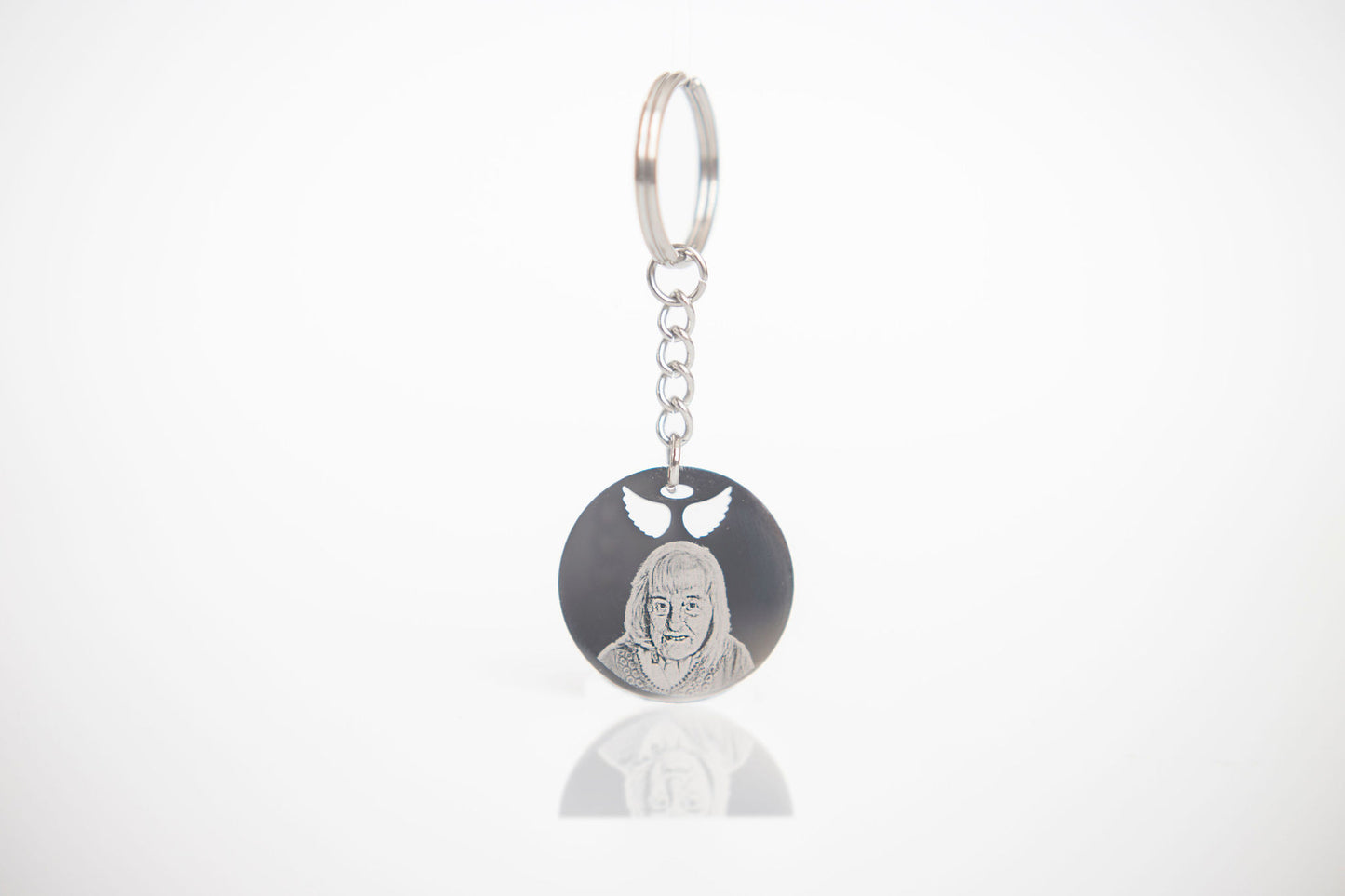 Keychain with engraved face on a white background