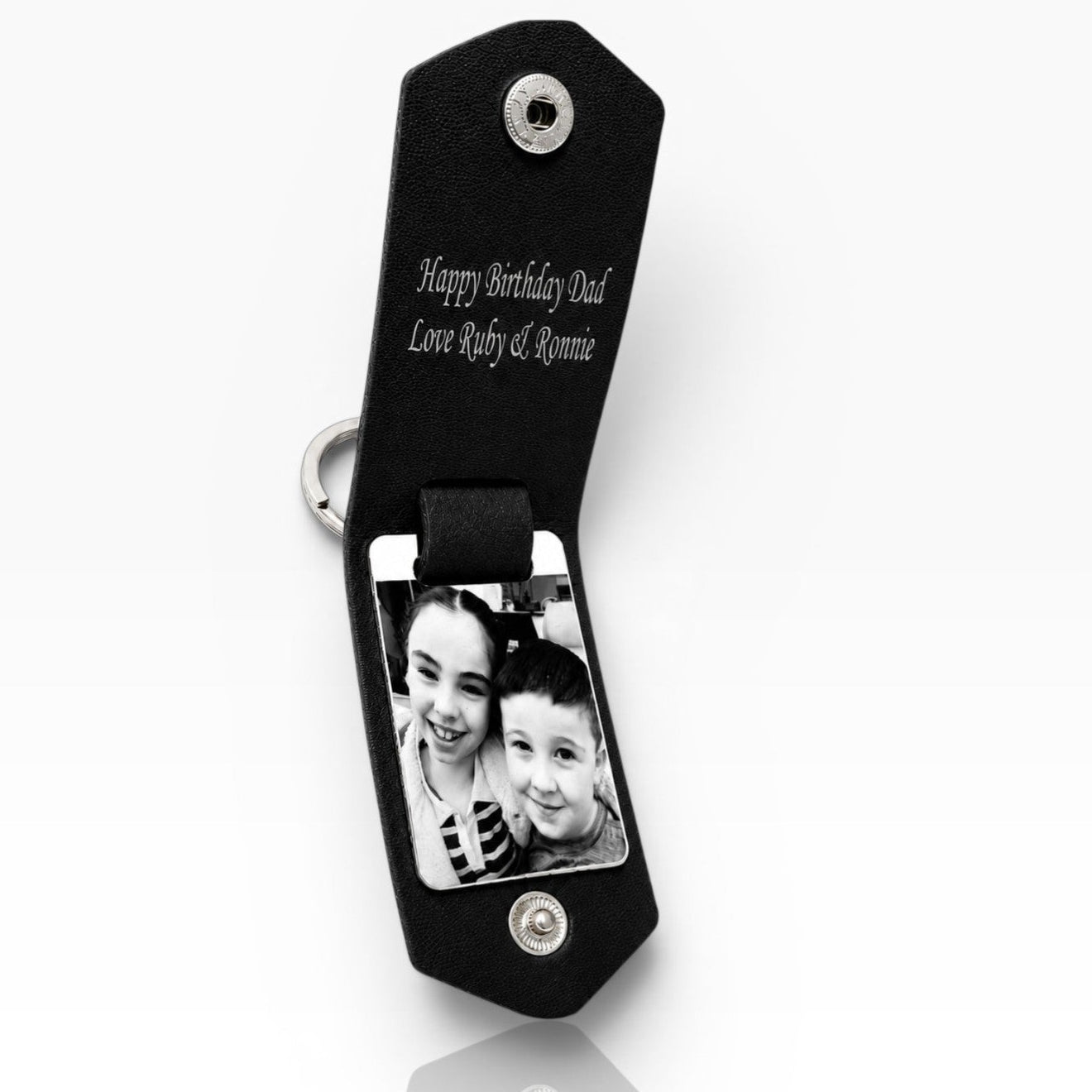 A black personalized photo keychain with a split ring, featuring a custom black-and-white photo of a father and child and the engraved text 'Happy Birthday Dad' on a white background.