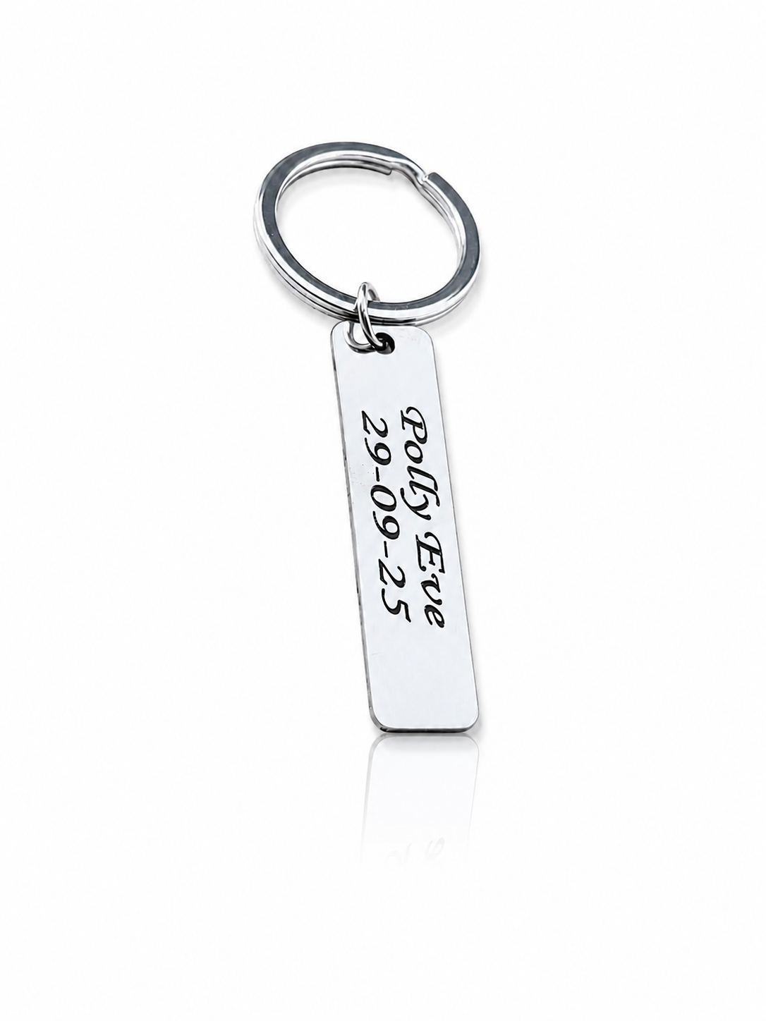 Silver keychain with engraved text on a white background