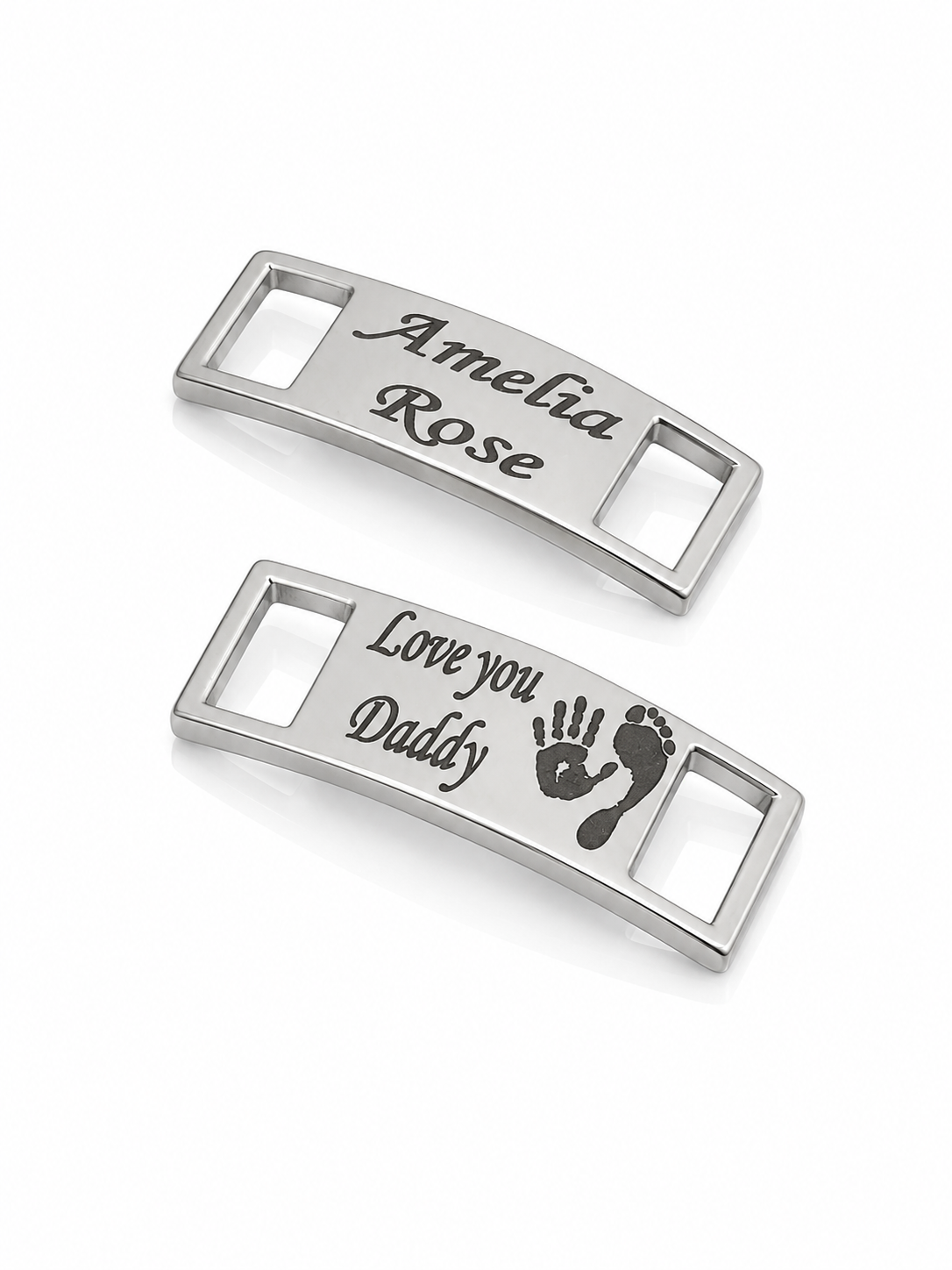 Two silver trainer charms with engraved text on a white background